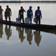 Indian election officials and paramilitary soldiers with election materials travel on a country boat across the river Brahmaputra on the eve of the first phase of the general election.